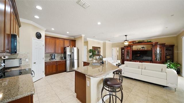 30 Cortes Ct, Palm Coast, FL 32137 - kitchen with stainless steel fridge, ornamental molding, decorative backsplash, light tile patterned flooring, and a breakfast bar