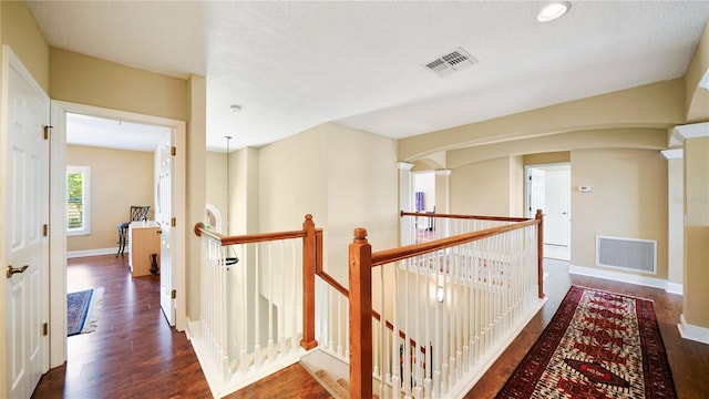 30 Cortes Ct, Palm Coast, FL 32137 - corridor with an upstairs landing, wood finished floors, and arched walkways