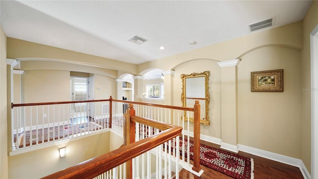 30 Cortes Ct, Palm Coast, FL 32137 - corridor featuring ornate columns, wood finished floors, an upstairs landing, and recessed lighting