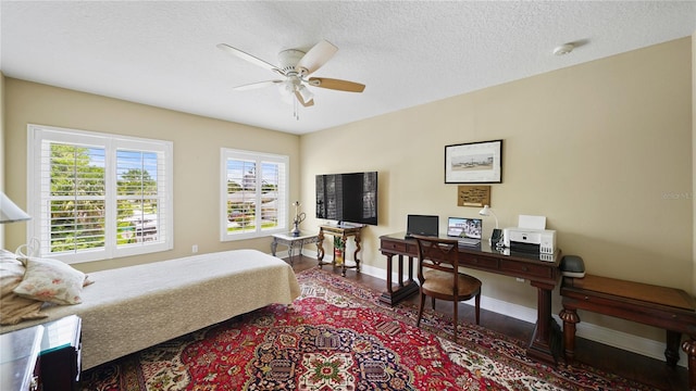 30 Cortes Ct, Palm Coast, FL 32137 - bedroom featuring a textured ceiling, a ceiling fan, wood finished floors, and an office area