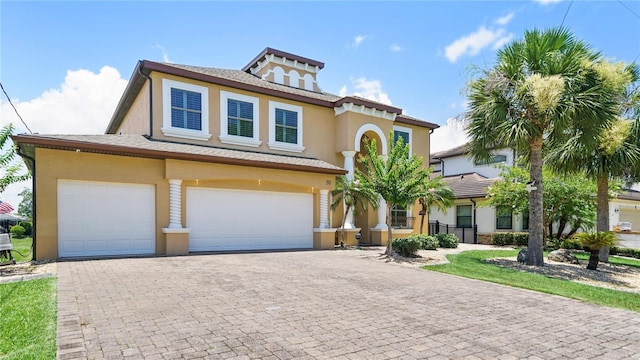 30 Cortes Ct, Palm Coast, FL 32137 - view of front of property featuring stucco siding, an attached garage, and decorative driveway