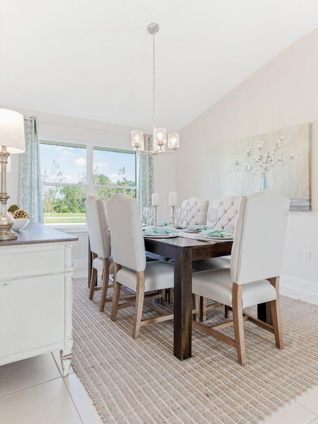 88 Rae Dr, Palm Coast, FL 32164 - dining area with a chandelier, light tile patterned floors, and vaulted ceiling