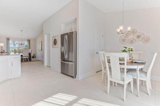 88 Rae Dr, Palm Coast, FL 32164 - dining area featuring a chandelier, lofted ceiling, and light tile patterned floors
