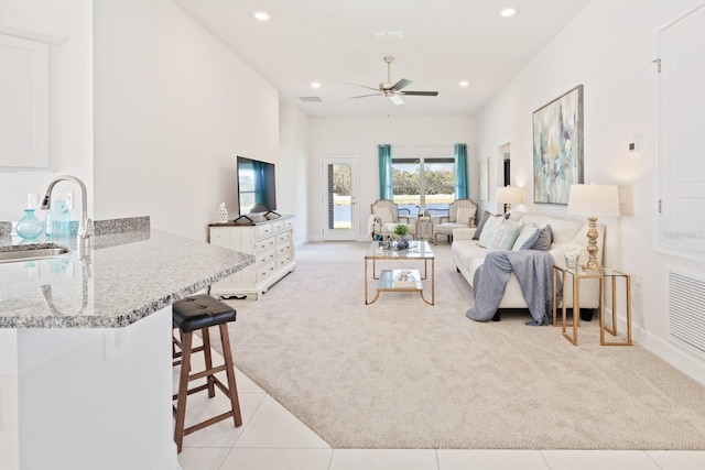 88 Rae Dr, Palm Coast, FL 32164 - living room with light colored carpet, a ceiling fan, and recessed lighting