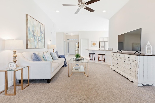 88 Rae Dr, Palm Coast, FL 32164 - living area featuring light colored carpet, a ceiling fan, and vaulted ceiling