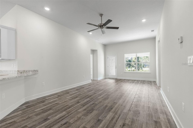 12 Wainshire Pl, Palm Coast, FL 32164 - unfurnished living room featuring dark wood finished floors, a ceiling fan, and recessed lighting