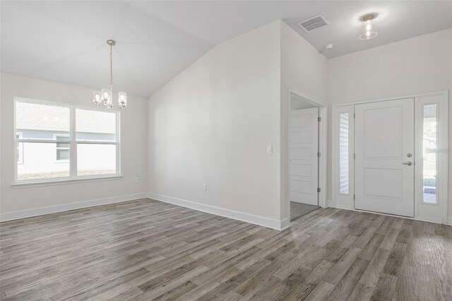 12 Wainshire Pl, Palm Coast, FL 32164 - entryway with a chandelier, wood finished floors, plenty of natural light, and lofted ceiling