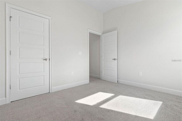 12 Wainshire Pl, Palm Coast, FL 32164 - unfurnished bedroom featuring carpet and baseboards