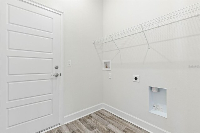 12 Wainshire Pl, Palm Coast, FL 32164 - laundry room featuring light wood-style floors, washer hookup, and hookup for an electric dryer