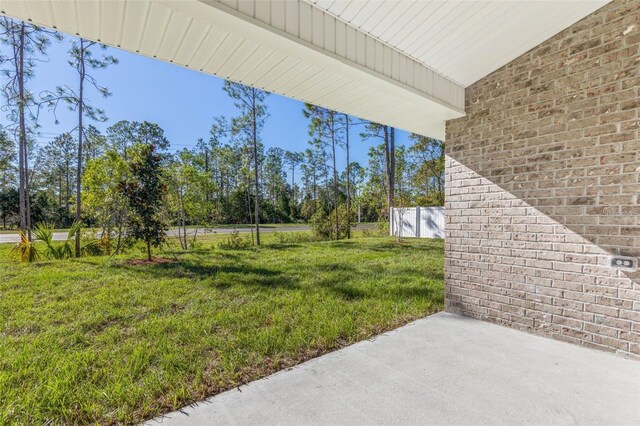 12 Wainshire Pl, Palm Coast, FL 32164 - view of green lawn featuring a patio area