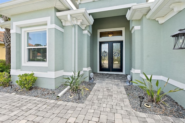 67 N Lakewalk Dr, Palm Coast, FL 32137 - doorway to property with french doors and stucco siding