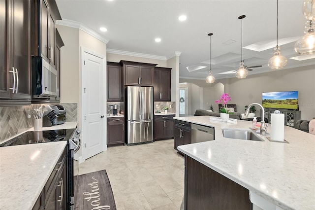 67 N Lakewalk Dr, Palm Coast, FL 32137 - kitchen with stainless steel appliances, crown molding, open floor plan, dark brown cabinets, and backsplash