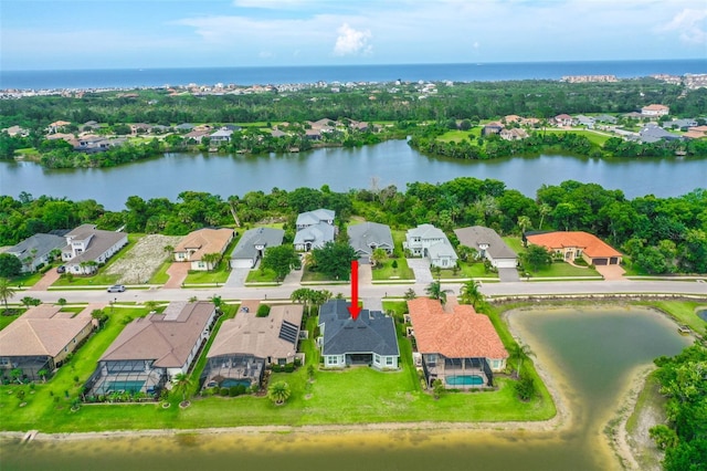 67 N Lakewalk Dr, Palm Coast, FL 32137 - aerial perspective of suburban area featuring a large body of water and a tree filled landscape