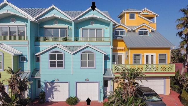 3000 Ocean Shore Blvd Unit 18, Ormond Beach, FL 32176 - view of front facade with an attached garage, a metal roof, and driveway