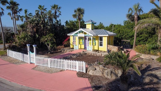 3000 Ocean Shore Blvd Unit 18, Ormond Beach, FL 32176 - view of front facade with a fenced front yard, a metal roof, and a standing seam roof