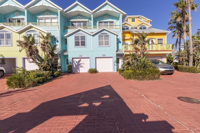 3000 Ocean Shore Blvd Unit 18, Ormond Beach, FL 32176 - view of front of property with decorative driveway, a garage, and a balcony