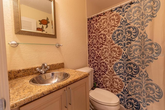 3000 Ocean Shore Blvd Unit 18, Ormond Beach, FL 32176 - full bath featuring a textured wall, vanity, and a shower with shower curtain