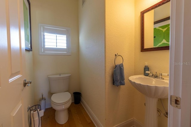 3000 Ocean Shore Blvd Unit 18, Ormond Beach, FL 32176 - half bathroom with toilet and wood finished floors