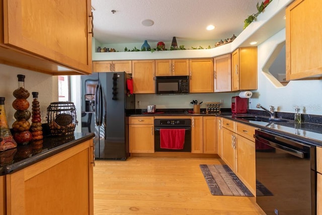 3000 Ocean Shore Blvd Unit 18, Ormond Beach, FL 32176 - kitchen featuring black appliances, light wood-style floors, a textured ceiling, dark stone countertops, and recessed lighting