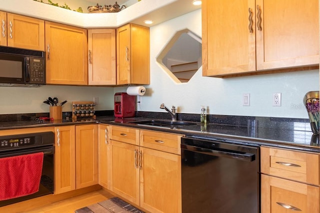 3000 Ocean Shore Blvd Unit 18, Ormond Beach, FL 32176 - kitchen with black appliances, light wood-style flooring, and dark stone countertops