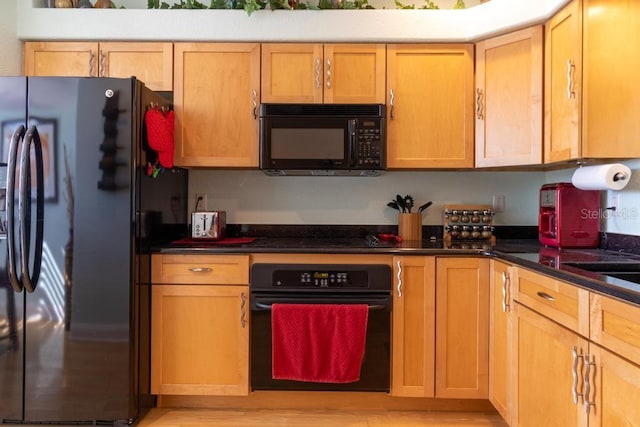 3000 Ocean Shore Blvd Unit 18, Ormond Beach, FL 32176 - kitchen featuring black appliances and light wood finished floors