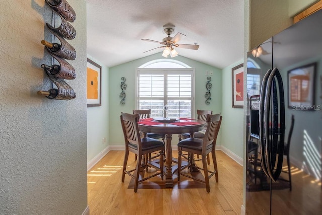 3000 Ocean Shore Blvd Unit 18, Ormond Beach, FL 32176 - dining space featuring vaulted ceiling, a ceiling fan, light wood-style floors, and a textured wall