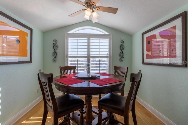 3000 Ocean Shore Blvd Unit 18, Ormond Beach, FL 32176 - dining room featuring light wood-style floors, vaulted ceiling, ceiling fan, a textured ceiling, and a textured wall