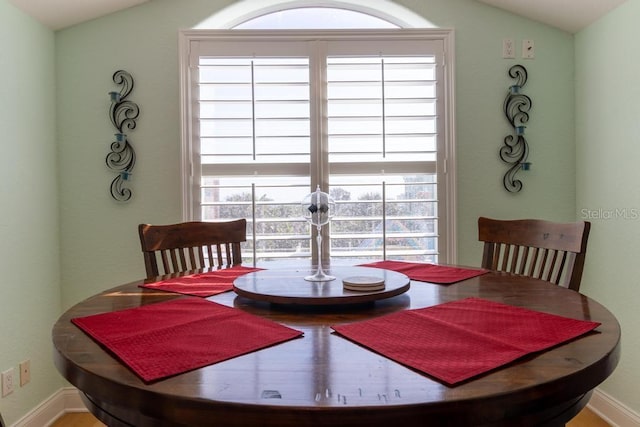3000 Ocean Shore Blvd Unit 18, Ormond Beach, FL 32176 - dining room with vaulted ceiling and wood finished floors