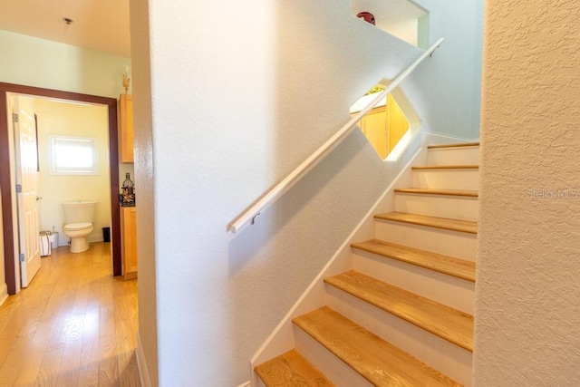 3000 Ocean Shore Blvd Unit 18, Ormond Beach, FL 32176 - staircase featuring wood finished floors and a textured wall