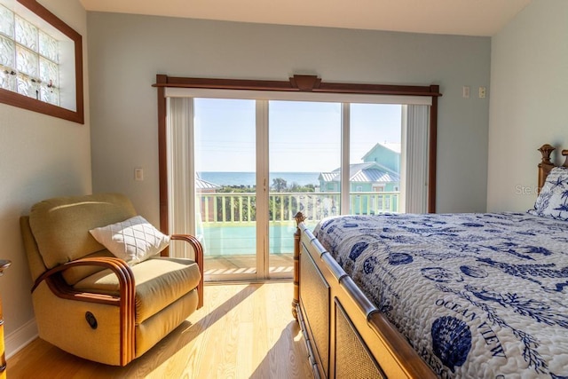 3000 Ocean Shore Blvd Unit 18, Ormond Beach, FL 32176 - bedroom featuring access to outside, light wood-type flooring, multiple windows, and a water view