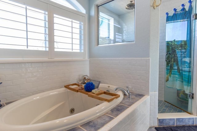 3000 Ocean Shore Blvd Unit 18, Ormond Beach, FL 32176 - full bathroom featuring a stall shower, a jetted tub, and plenty of natural light