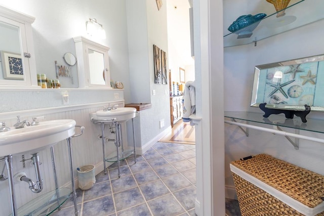 3000 Ocean Shore Blvd Unit 18, Ormond Beach, FL 32176 - bathroom with tile patterned floors and a wainscoted wall