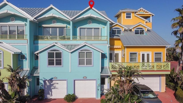 3000 Ocean Shore Blvd Unit 18, Ormond Beach, FL 32176 - view of front facade featuring an attached garage, a metal roof, and driveway