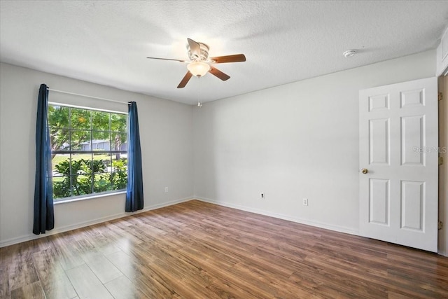 37 Lindsay Dr, Palm Coast, FL 32137 - empty room with ceiling fan, wood finished floors, a smoke detector, and a textured ceiling