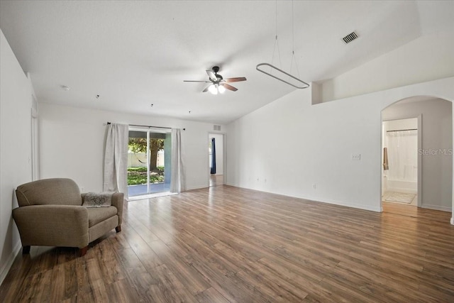37 Lindsay Dr, Palm Coast, FL 32137 - living room featuring arched walkways, wood finished floors, ceiling fan, and vaulted ceiling