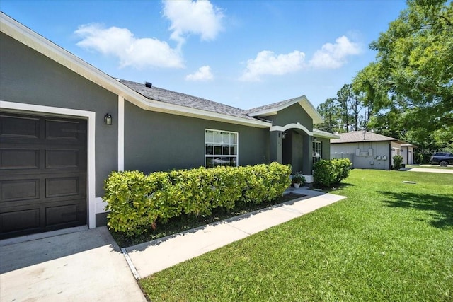 37 Lindsay Dr, Palm Coast, FL 32137 - view of front of property featuring an attached garage, stucco siding, and a front lawn