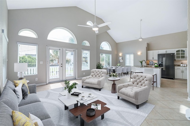 1115 N Central Ave, Flagler Beach, FL 32136 - living room with high vaulted ceiling, light tile patterned floors, ceiling fan, and french doors
