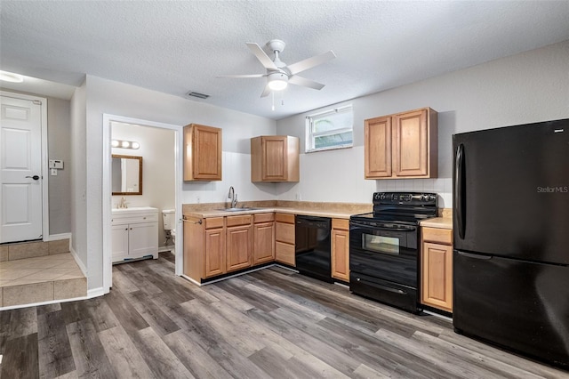 1115 N Central Ave, Flagler Beach, FL 32136 - kitchen with black appliances, light countertops, ceiling fan, dark wood-style flooring, and a textured ceiling
