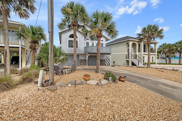 1115 N Central Ave, Flagler Beach, FL 32136 - raised beach house with stairs, driveway, stucco siding, and an attached garage