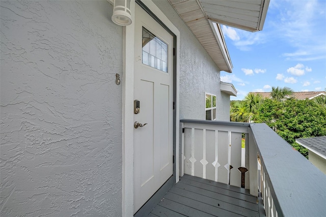 1115 N Central Ave, Flagler Beach, FL 32136 - property entrance with stucco siding and a balcony
