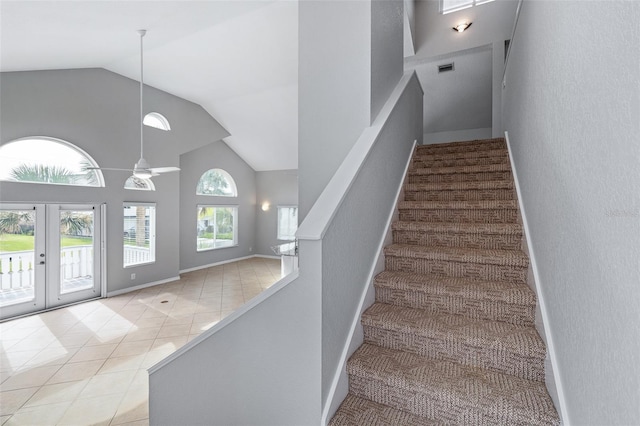 1115 N Central Ave, Flagler Beach, FL 32136 - staircase featuring high vaulted ceiling, french doors, and tile patterned flooring