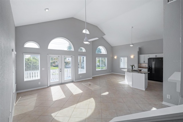 1115 N Central Ave, Flagler Beach, FL 32136 - kitchen with black fridge, open floor plan, high vaulted ceiling, a ceiling fan, and french doors