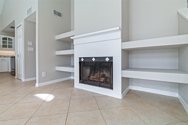 1115 N Central Ave, Flagler Beach, FL 32136 - unfurnished living room featuring light tile patterned floors, a fireplace, and built in shelves