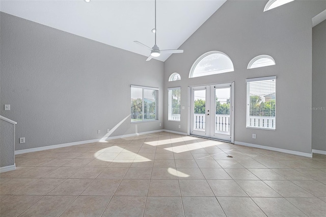 1115 N Central Ave, Flagler Beach, FL 32136 - tiled empty room with ceiling fan, french doors, high vaulted ceiling, and a textured wall