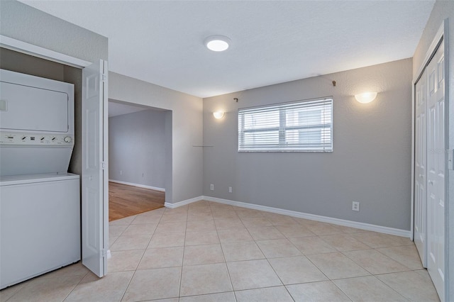 1115 N Central Ave, Flagler Beach, FL 32136 - spare room with estacked washer and dryer and light tile patterned floors