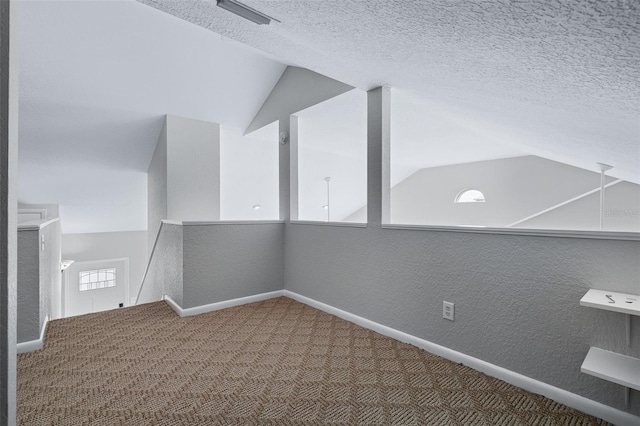 1115 N Central Ave, Flagler Beach, FL 32136 - additional living space with carpet floors, vaulted ceiling, a textured wall, and a textured ceiling