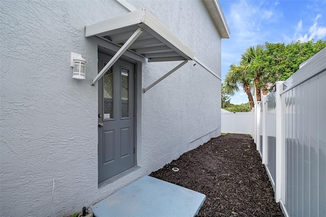 1115 N Central Ave, Flagler Beach, FL 32136 - doorway to property featuring stucco siding