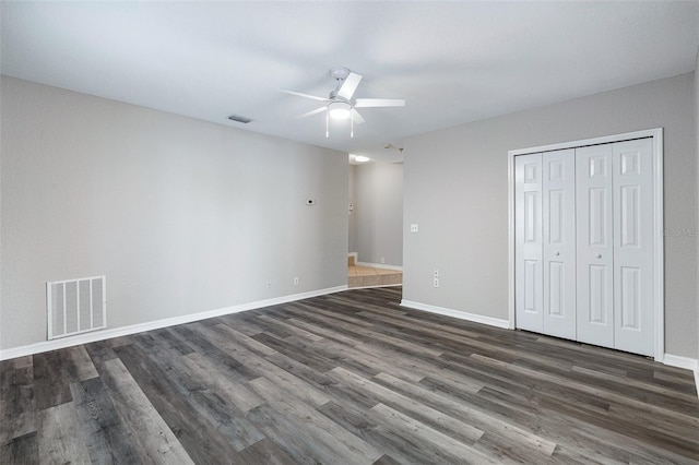 1115 N Central Ave, Flagler Beach, FL 32136 - unfurnished bedroom featuring dark wood-style flooring, a closet, and a ceiling fan