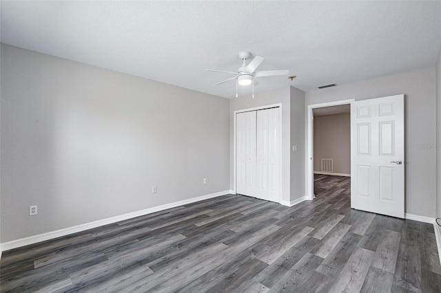 1115 N Central Ave, Flagler Beach, FL 32136 - unfurnished bedroom with a closet, dark wood finished floors, a ceiling fan, and a textured ceiling