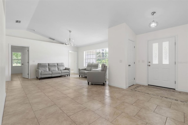 23 Pennfield Ln, Palm Coast, FL 32164 - entryway featuring vaulted ceiling, a chandelier, and light tile patterned flooring